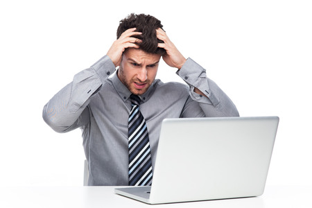 Frustrated Man Staring at Laptop Screenの写真素材