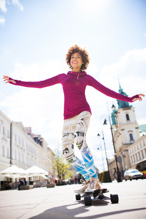 Young woman skateboardingの写真素材
