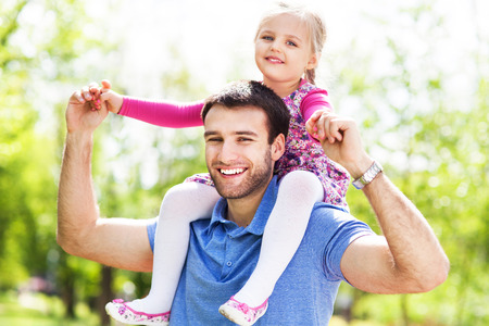 Father Giving Daughter Piggyback Rideの写真素材
