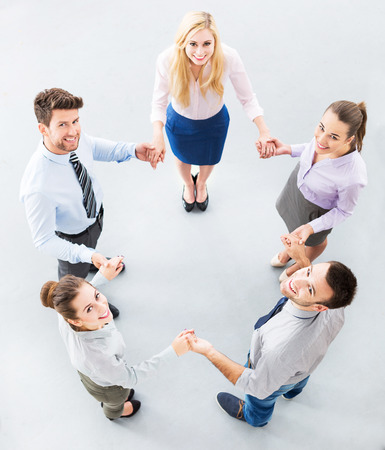 Business people joining hands in circleの写真素材