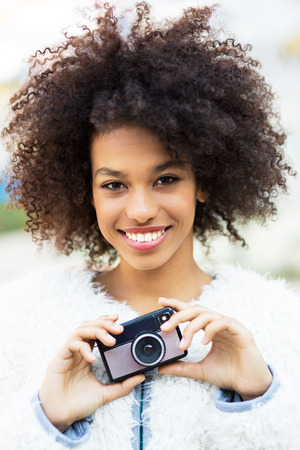 African American woman with vintage cameraの写真素材