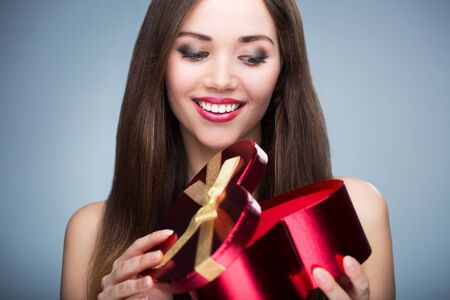 Woman opening heart shaped boxの写真素材