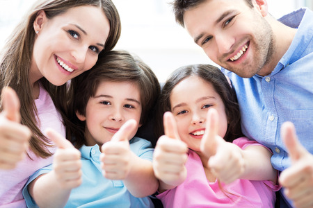 Family showing thumbs upの写真素材