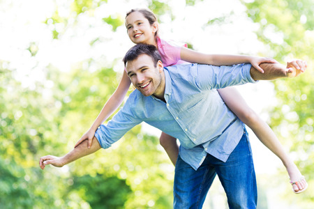 Father and daughter playing outdoorsの写真素材