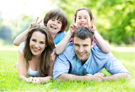 Family outdoors lying on grassの写真素材