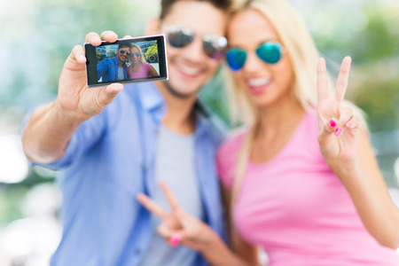 Couple taking a selfie with smartphone