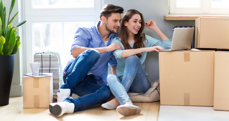 Couple with unpacked boxes in new home