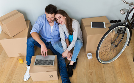 Couple with unpacked boxes in new home