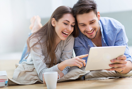 Couple using digital tablet togetherの写真素材