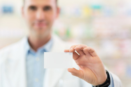 Pharmacist holding blank cardの写真素材