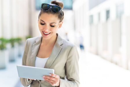 Attractive young woman using digital tabletの写真素材