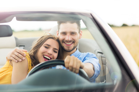 Couple enjoying a drive in a convertible