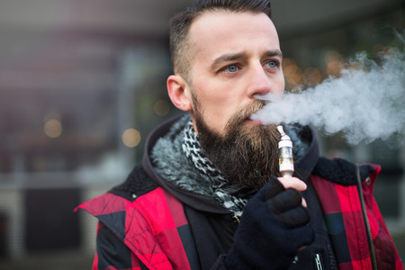 Young bearded man smoking