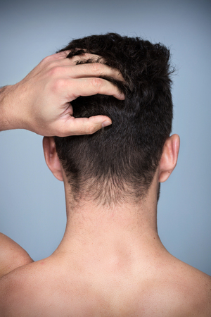 Man touching his hairの写真素材