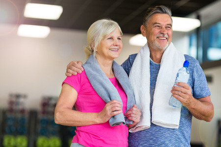 Senior couple exercising in gymの写真素材