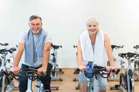 Senior couple exercising in gymの写真素材