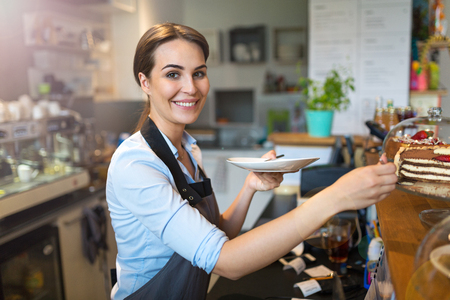 Small business owner standing in a coffee shopの写真素材