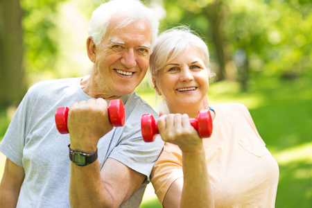 Senior Couple Exercising In Parkの写真素材