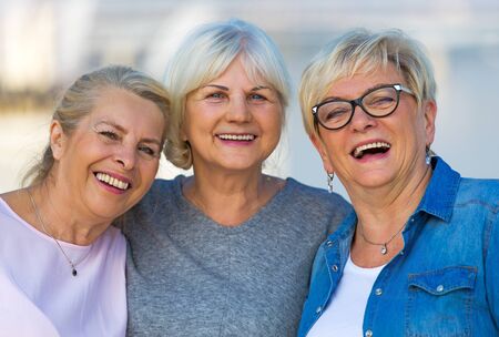 Group of smiling senior women standing outsideの写真素材