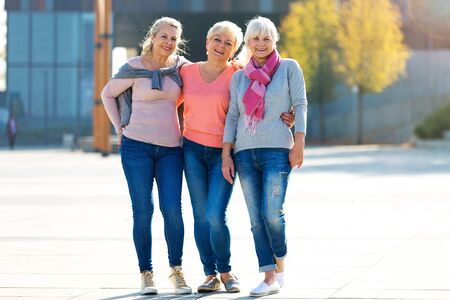 Group of smiling senior women standing outsideの写真素材