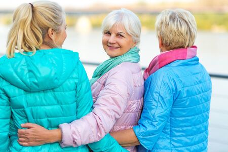 Group of smiling senior women standing outsideの写真素材