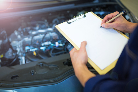 Hands of mechanic working in auto repair shopの写真素材