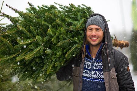 Young Man Buying Christmas Treeの写真素材