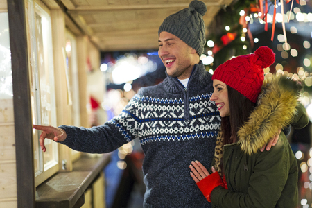 Young Couple Having Fun Outdoors At Christmas Timeの写真素材