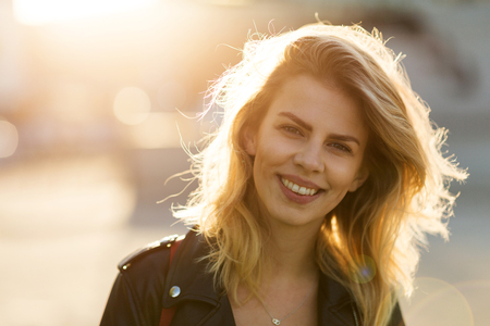 Young woman in the city at sunsetの写真素材