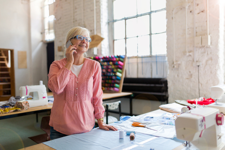 Confident senior fashion designer in her workshopの写真素材