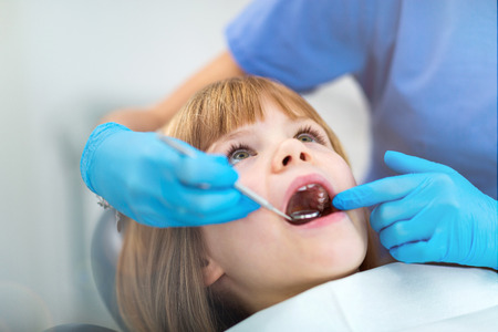 Young girl have a checkup at the dentistの写真素材
