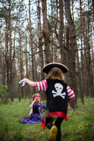 Children playing in the forest wearing costumesの写真素材