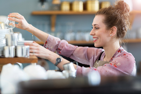 Woman working in coffee shopの写真素材