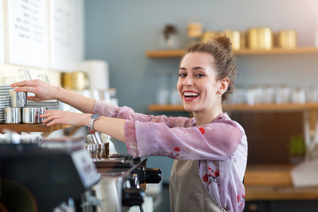 Woman working in coffee shopの写真素材