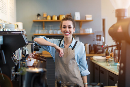 Woman working in coffee shopの写真素材