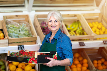 Senior woman working in small grocery storeの写真素材