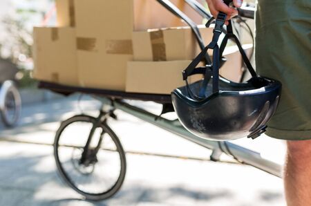 Bicycle messenger making a delivery on a cargo bike