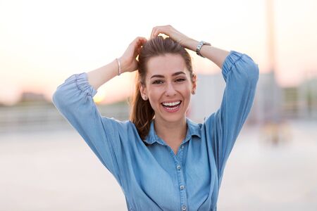 Portrait of a girl on a rooftop enjoying sunset