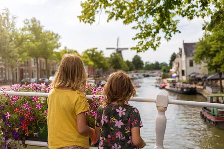 Rear view of two little girls looking at view on bridge, Dokkum, Hollandの写真素材