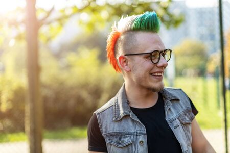 Portrait of a cool young man with colorful mohawk hair