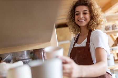 Portrait of woman pottery artist in art studioの写真素材