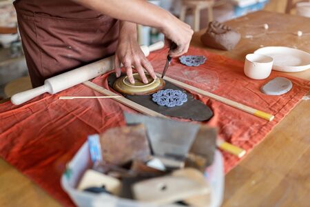 Woman pottery artist makes ceramics from clayの写真素材