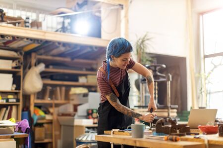 Craftswoman working in her workshopの写真素材