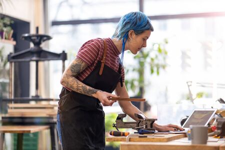 Young woman using laptop in her workshop