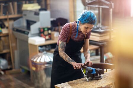 Young woman doing woodwork in a workshop