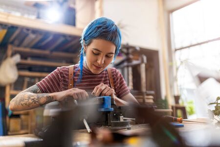 Young woman doing woodwork in a workshop