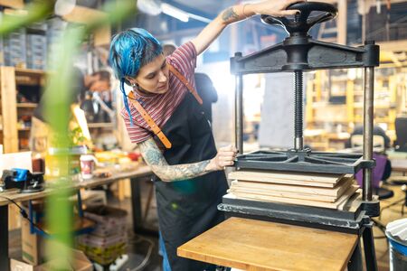 Young woman doing woodwork in a workshop