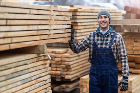 Young male worker in timber warehouseの写真素材