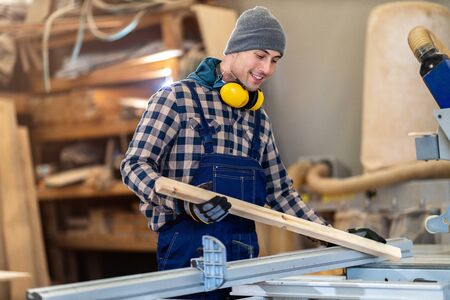 Young male worker in timber warehouseの写真素材