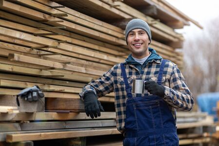 Young male worker in timber warehouseの写真素材